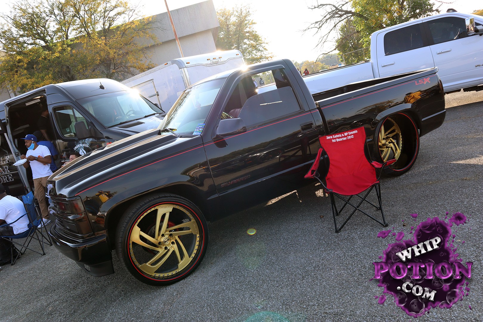 This black Chevy Silverado hits hard with a clean two-tone pinstripe, deep-tinted glass, and massive gold 5-spoke wheels tucked under the bed. The lowered stance and shaved, monochrome look give it a polished custom-truck vibe, while the LSX marking on the bed and the big wheel fit make the whole build feel properly dialed-in.