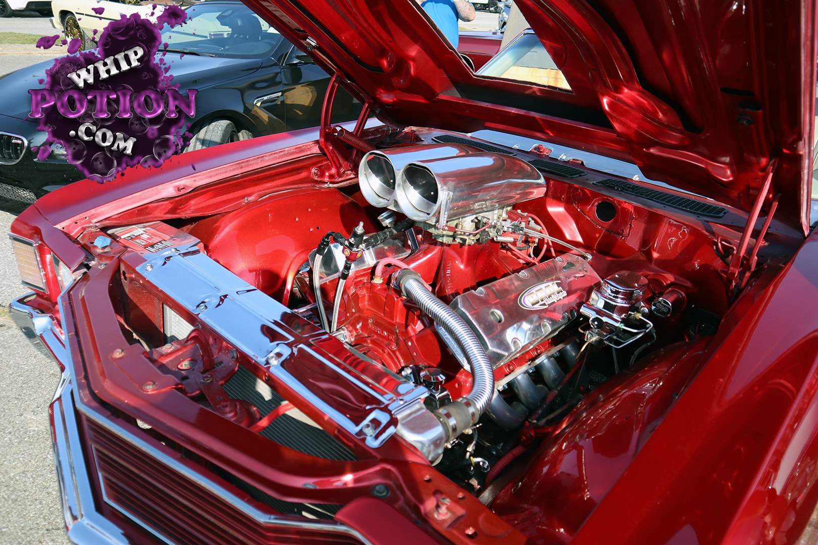 This red classic Chevrolet pickup is all about the engine bay, with a fully color-matched finish, mirror-bright valve covers, and a big polished intake setup sitting front and center. The chrome radiator support and tucked wiring give it a clean, show-ready look, while the open hood lets the whole built V8 presentation do the talking.