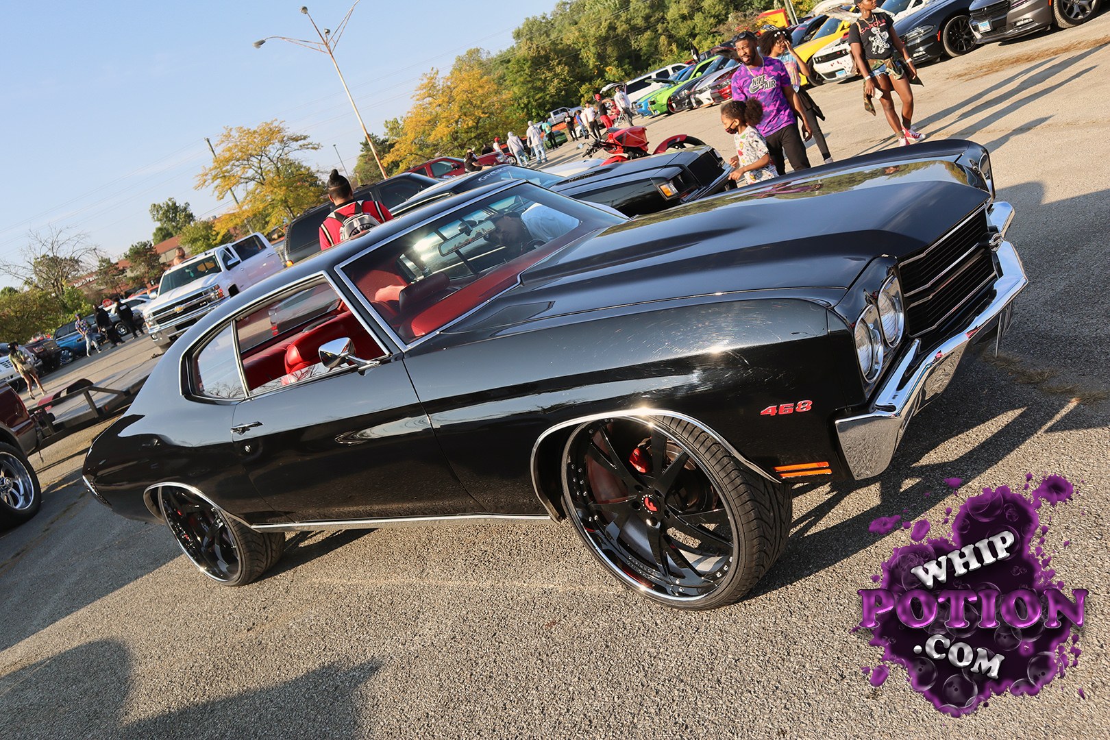 This black Chevrolet Chevelle has the right kind of street presence, with a glossy finish, bright chrome trim, and a red interior that pops through the glass. The 468 badge on the fender and the oversized black-and-chrome wheels give it a serious muscle-car stance, while the clean bodylines keep it looking mean without overdoing it.