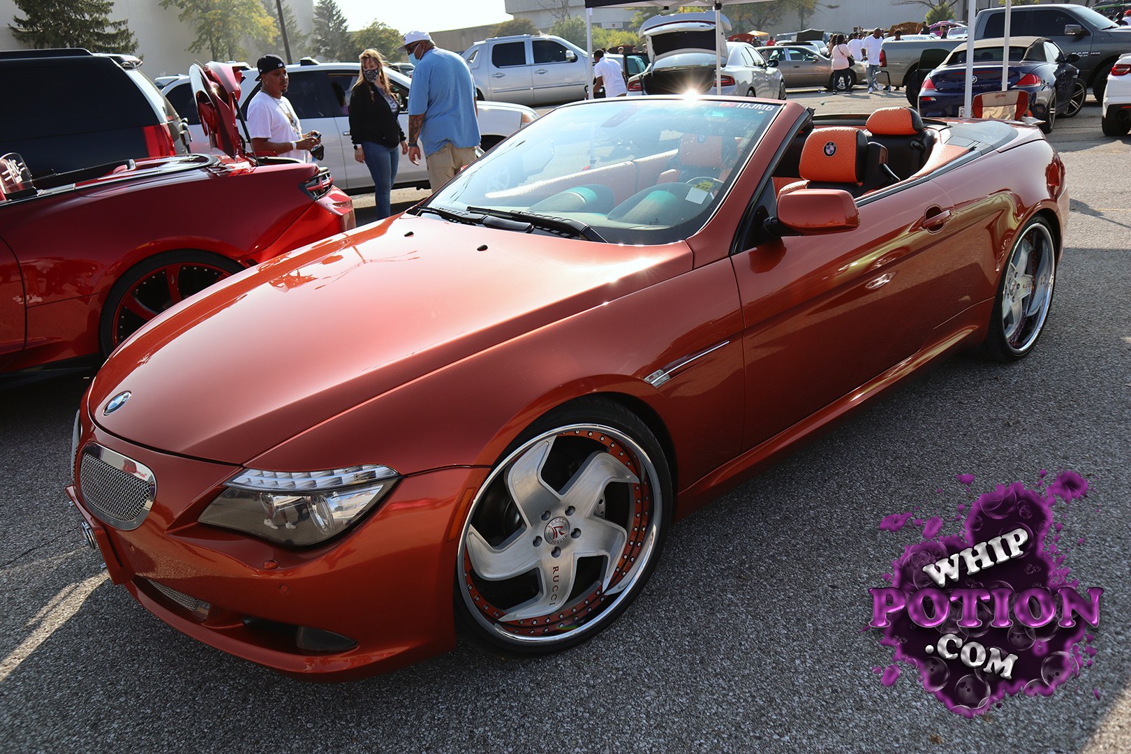 A metallic burnt-orange BMW 6 Series convertible sits low on polished custom wheels, with a clean body kit and a deep shine that really fits the car’s long, sculpted lines. The orange-and-black interior adds a bold contrast, and the whole build has that polished show-car feel without losing the factory elegance that makes the 6 Series work so well.