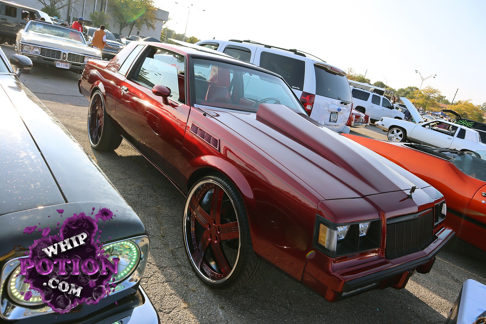 This burgundy Oldsmobile Cutlass coupe nails the early-’80s G-body look with a sharp custom stance, giant multi-spoke wheels, and a clean two-tone red interior visible through the glass. The shaved, monochrome bodywork and deep-dish setup give it that polished street-machine vibe without losing the classic Olds personality.