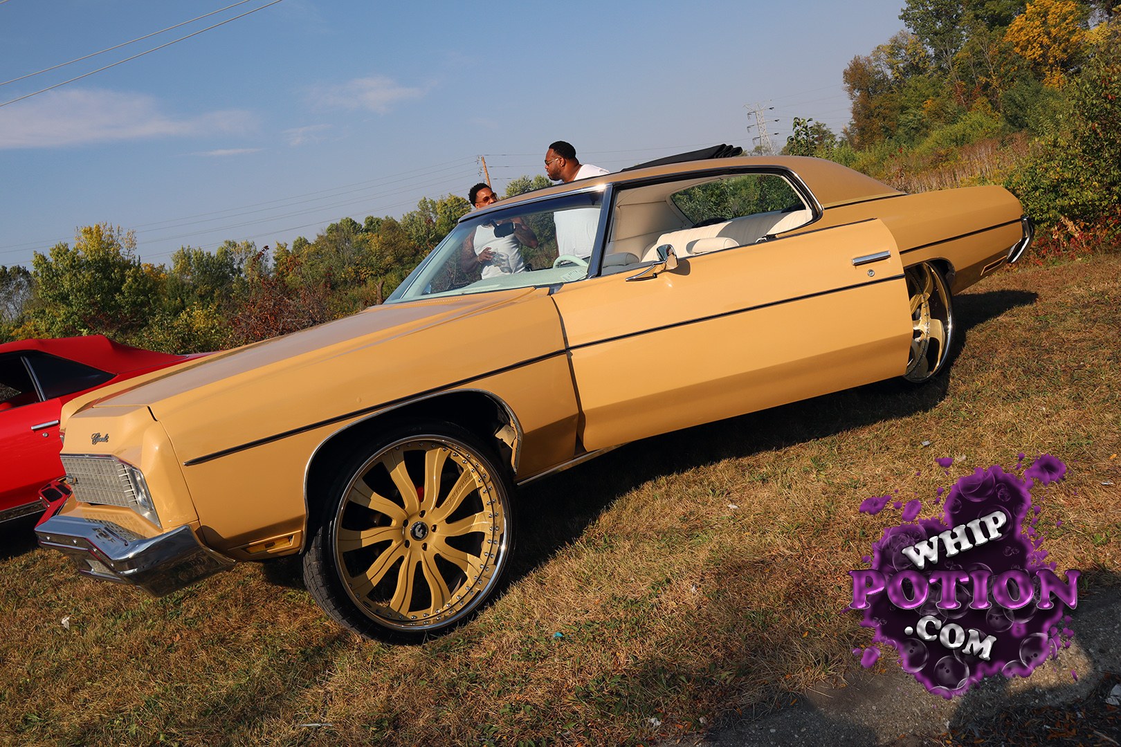 This classic Buick coupe brings serious boulevard presence with its gold paint, white interior, and massive chrome-and-gold wheels tucked under a clean, long-roof profile. The hardtop lines and vintage front clip give it that old-school luxury feel, while the custom stance and overall finish make it a standout build for anyone who loves well-done land yachts.