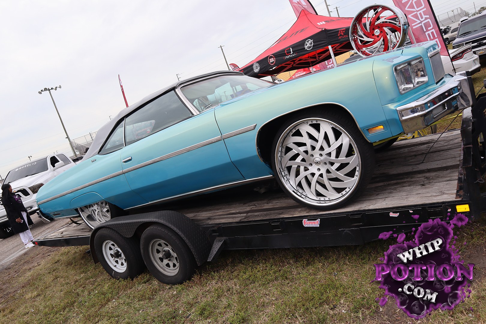 This classic Chevrolet coupe carries a clean two-tone blue fade with a black vinyl top and sits on huge billet-style wheels that fill the wells just right. The long, low body and squared-off front end give it real ’70s cruiser appeal, and the polished trim keeps the whole build looking sharp without overdoing it.