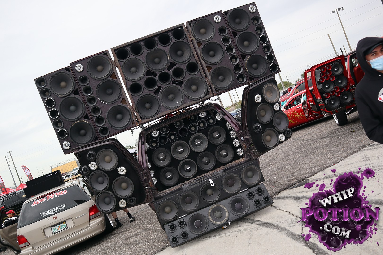 A wild Honda wagon gets turned into a full-on sound wall, with a massive hinged speaker array unfolding from the rear and packing rows of subwoofers and mids. The beige body stays relatively clean and simple, which makes the custom audio setup hit even harder. It’s the kind of build that exists purely for bass and bragging rights.
