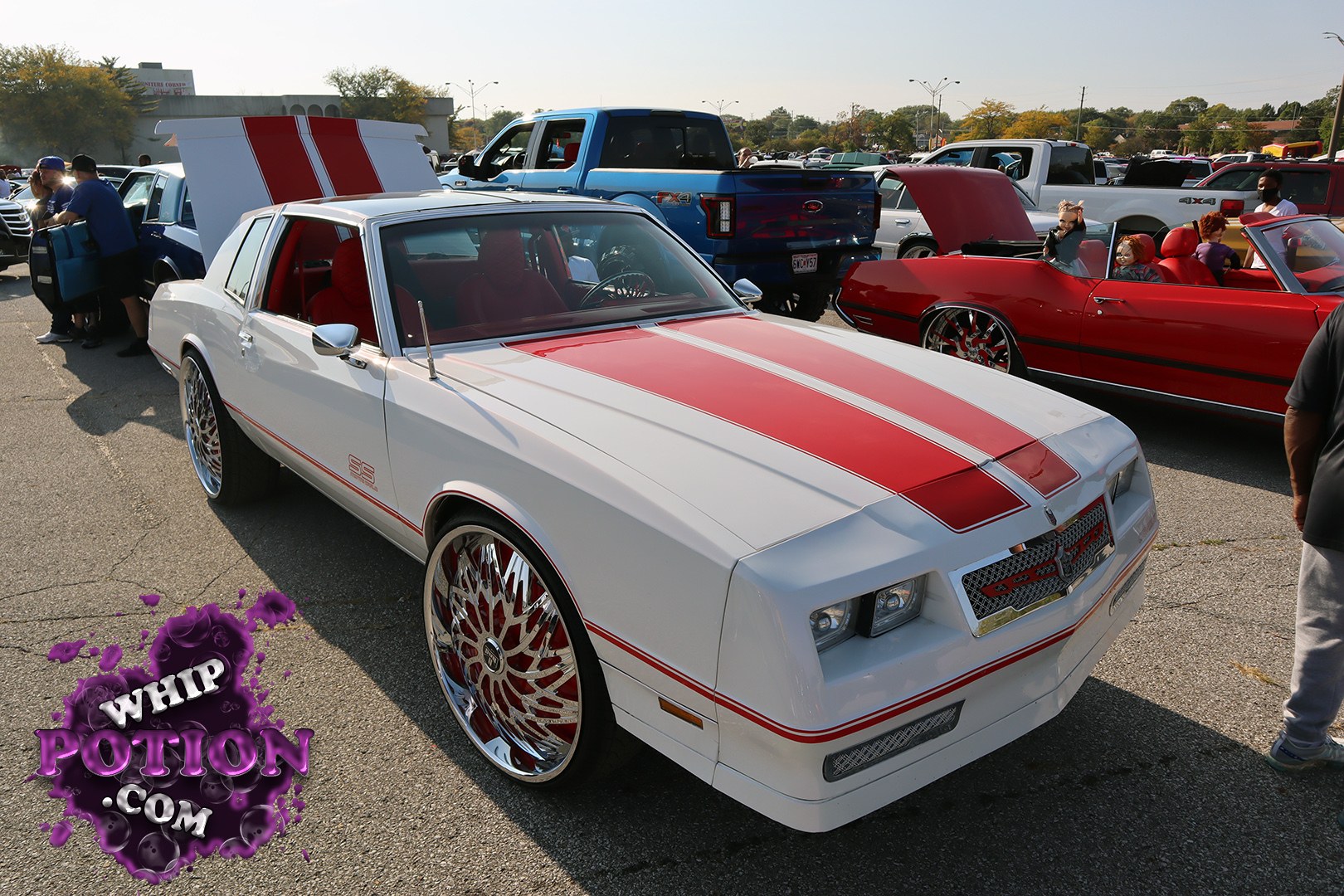This classic Chevy Monte Carlo SS wears a clean white-and-red combo that suits the sharp body lines perfectly. The bold twin stripes, cowl hood, and deep-dish chrome wheels give it a serious street presence, while the red interior ties the whole build together. It’s got that old-school muscle vibe with just enough custom flair to feel personal.